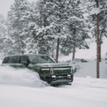 Rivian R1S being driven on a snow covered road