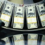 Bundles of freshly printed $100 bills roll through a conveyor belt at the United States Department of Treasury.