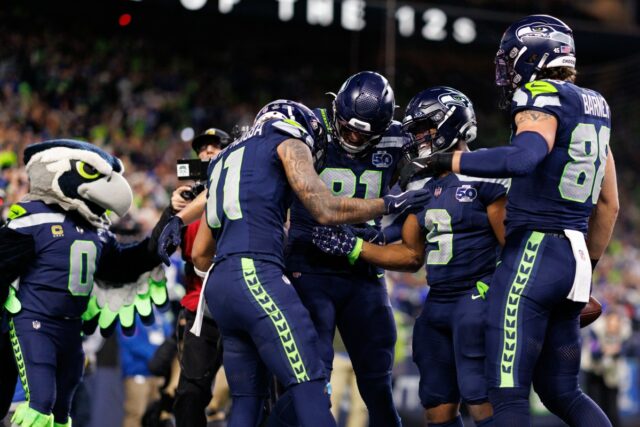 Sam Darnold #14 of the Seattle Seahawks calls a play in the huddle during the first quarter of an NFL divisional playoff football game against the San Francisco 49ers at Lumen Field on January 17, 2026 in Seattle, Washington.