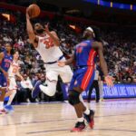 Karl-Anthony Towns # 32 do New York Knicks recebe um segundo tiro em torno de Isaiah Stewart # 28 do Detroit Pistons na Little Caesars Arena em 05 de janeiro de 2026 em Detroit, Michigan.