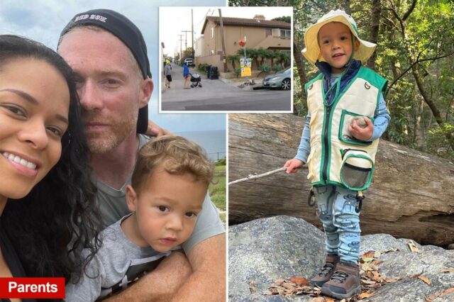 Hudson O'Loughlin vestindo um colete de pesca, segurando um pedaço de pau e uma pedra, de pé sobre pedras com um tronco caído e árvores ao fundo.