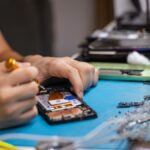 Um telefone sobre uma mesa, conectado, com um logotipo de aviso na tela