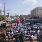 File photo: Performers parade with giant marionettes and drums during a street procession at an art festival in Bamako, Mali, on November 6, 2025.