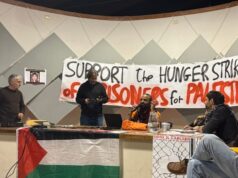 Por que estou em greve de fome em solidariedade aos detidos da Pal Action Uma sala com pôster com fotos de 8 grevistas de fome da Ação Palestina