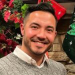 Burke sorrindo em uniforme marinho