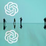 This photograph taken in Mulhouse, eastern France on October 19, 2023, shows figurines next to the ChatGPT logo. (Photo by SEBASTIEN BOZON/AFP via Getty Images)