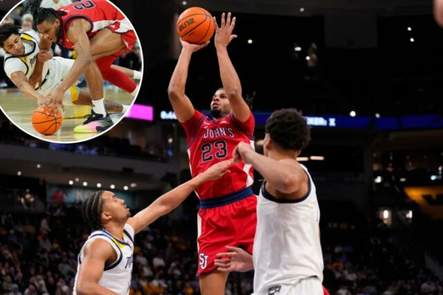 O atacante do St. John's Red Storm, Bryce Hopkins (23), chuta sobre o atacante do Marquette Golden Eagles, Royce Parham (13).