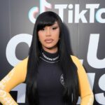 Nicki Minaj se junta ao presidente Donald Trump no palco enquanto ele faz comentários durante a Cúpula de Contas Trump do Departamento do Tesouro no Auditório Andrew W. Mellon em 28 de janeiro de 2026 em Washington, DC. (Foto de Win McNamee/Getty Images)