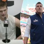 Drake Maye em uniforme dos Patriots com o número 10, olhando para baixo com desânimo.