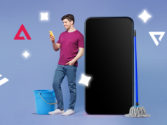 Finalmente estou ‘organizado digitalmente’ e levou apenas uma tarde Uma mão segurando um smartphone mostrando uma lista de aplicativos selecionados para exclusão, com um menu de classificação definido como “Menos usados” e uma lixeira chamada “Desinstalar aplicativos” em segundo plano.