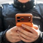 uma pessoa olhando para um telefone nas mãos