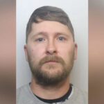 Tribunal da Coroa de Newcastle. Um edifício imponente feito de pedra vermelha lisa com enormes janelas pretas e colunas altas ao longo de sua fachada.