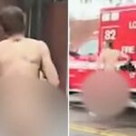 Um homem nu e desfocado passando por um caminhão vermelho do Corpo de Bombeiros da cidade de Los Angeles em uma cena de acidente em East Hollywood.