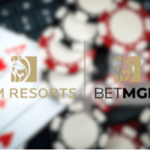 MGM Resorts e BetMGM expandem o investimento em jogos responsáveis ​​em todo o país nesta primavera. Os logotipos MGM Resorts e BetMGM exibidos lado a lado sobre um fundo desfocado de fichas de pôquer e cartas de baralho, incluindo um ás de espadas, representando cassino e jogos online.