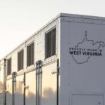 A grid-scale battery stands against a clear sky.
