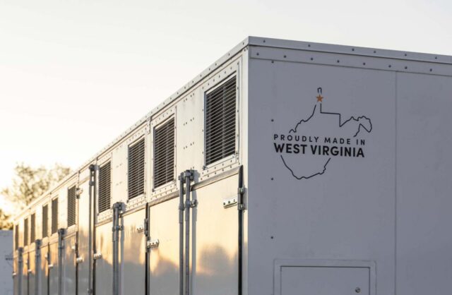 A grid-scale battery stands against a clear sky.