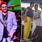 O músico Chuck Negron se apresentando no palco com um microfone.