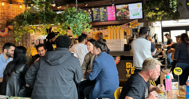 Os australianos não comem burritos suficientes. Custou apenas a uma Detalhe do logotipo oculto de Guzman y Gomez