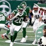 O running back dos Jets, Breece Hall (20), corre a bola durante um jogo contra o New England Patriots.