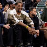 O lado defensivo do New Orleans Saints, Cam Jordan, assistindo a um jogo de basquete.