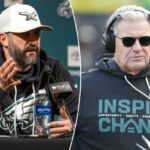 Um treinador dos Eagles usa óculos escuros e fones de ouvido, com um