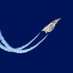 Dollar shaped paper airplane flying up