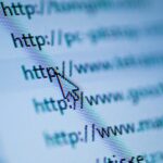 Cursor arrow pointing at URL on screen