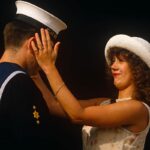 A woman with her hands on the face of her sailor husband ahead of a Buckingham Palace garden party in after sunshine in London in the United Kingdom.
