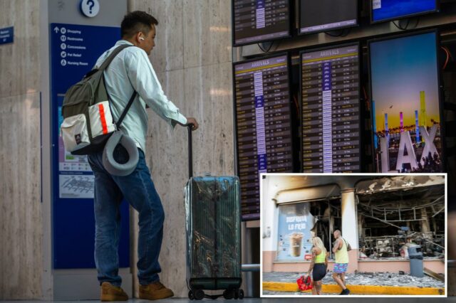 Um viajante olha para um quadro de aeroporto que mostra chegadas e partidas.