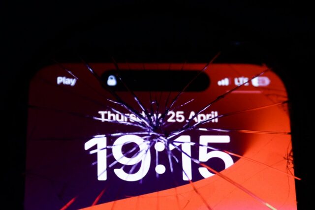 iPhone screen is seen through the broken glass in this illustration photo taken in Krakow, Poland on April 25, 2024.