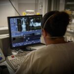 Doctor observing the images of a scanner in the emergency room of a university hospital.