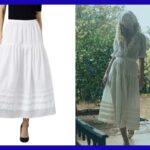 Saia midi branca com cintura franzida, detalhes em pintuck e barra com acabamento em renda.