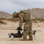 A US soldier prepares an Anduril-built drone for flight during a training exercise.
