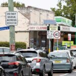 Carros fazendo fila em frente a um posto de gasolina em Mascot, Sydney.