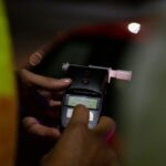 A police officer administers a breathalyser breath alcohol test after stopping a driver, on December 02, 2022 in Bournemouth, England.