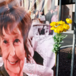 A photograph of Nancy Guthrie is displayed on a banner in front of the KVOA television station on March 01, 2026 in Tucson, Arizona