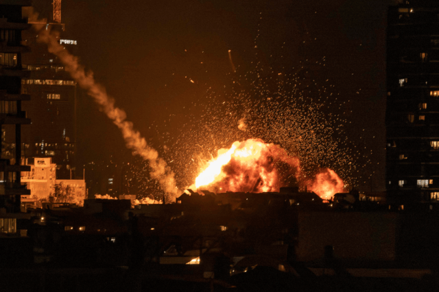 A fireball lights the sky following a missile strike on Tel Aviv on February 28, 2026.