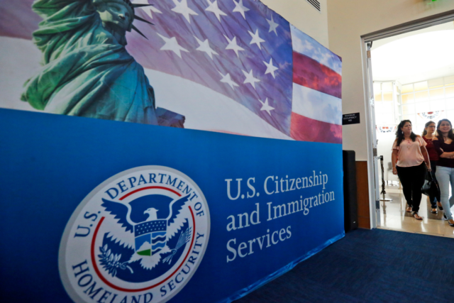 FILE - In this Aug. 17, 2018, file photo, people arrive before the start of a naturalization ceremony at the U.S. Citizenship and Immigration Services Miami Field Office in Miami.