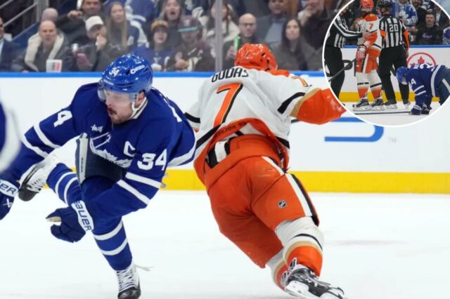 Toronto Maple Leafs Auston Matthews (34) é ferido por Anaheim Ducks Radko Gudas (7) durante um jogo de hóquei.