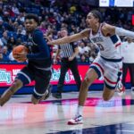 KJ Lewis drives against Jayden Ross of UConn Huskies