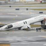 Comissário de bordo jogado e ainda preso no assento sobrevive ao acidente do LaGuardia