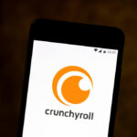 In this photo illustration a Crunchyroll logo seen displayed