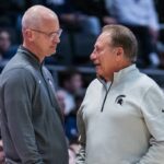 Dan Hurley and Tom Izzo chat during a UConn and Michigan State basketball game