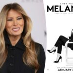 Melania Trump, vestindo um casaco preto, sorri levemente.