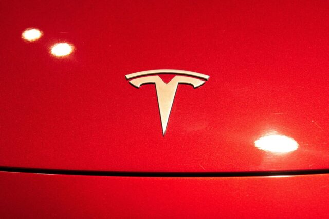 A Tesla logo seen on a Tesla Model 3 car.