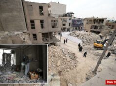 Israel ‘expandindo o escopo’ dos ataques contra o Irã: IDF Uma pessoa usando uma cobertura para a cabeça, máscara facial e luvas vasculha escombros em uma sala danificada em Teerã.