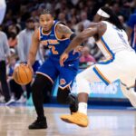 Miles McBride #2 do New York Knicks traz a bola para a quadra em torno de Luguentz Dort #5 do Oklahoma City Thunder durante o segundo tempo no Paycom Center em 29 de março de 2026 em Oklahoma City, Oklahoma.