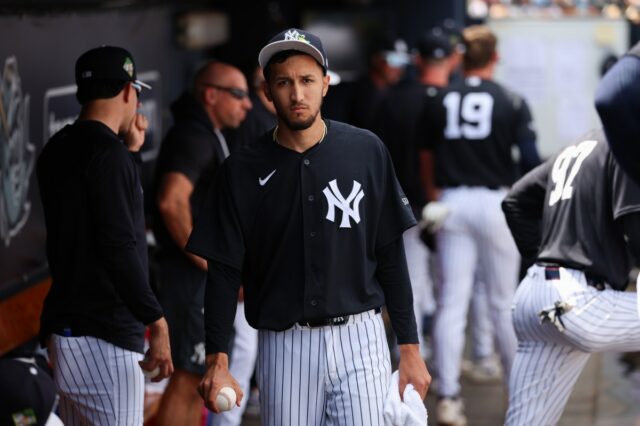 Yankees pitcher Elmer Rodriguez watches from the dugout.