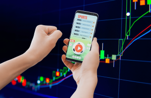 Os americanos veem os mercados de previsão esportiva como jogos de azar, conforme pesquisa revela preocupação crescente Os americanos veem os mercados de previsão esportiva à medida que a pesquisa sobre jogos de azar revela uma preocupação crescente. Aplicativo de apostas esportivas em smartphone com fundo gráfico crescente do mercado de ações, ilustrando mercados de previsão, jogos de azar on-line e conceitos de risco de negociação financeira