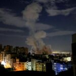 A smoke plume rises following a missile strike on a building in Tehran on March 1, 2026.